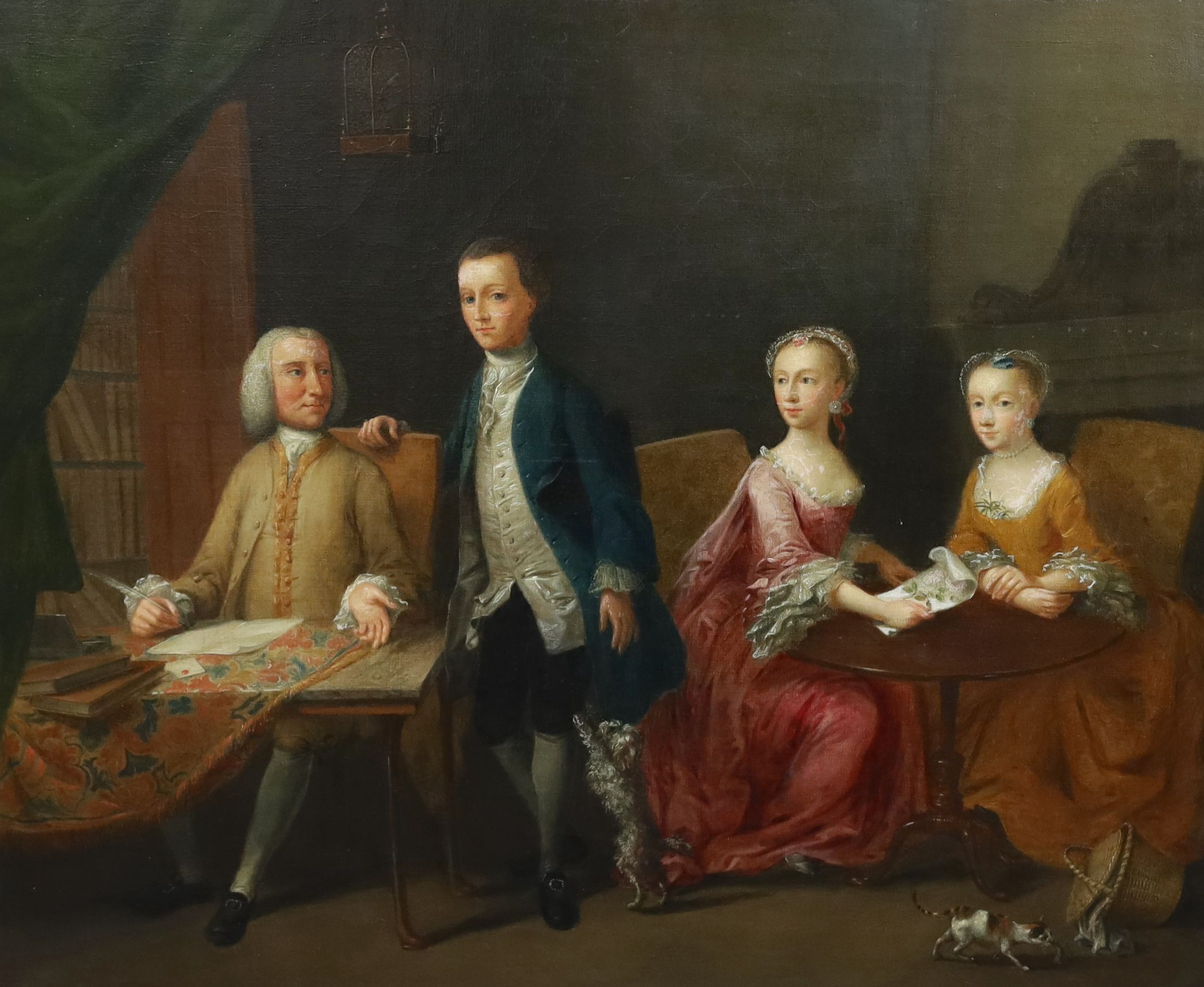 Manner of Arthur Devis (1712-1787), Family portrait, interior with a gentleman seated at a writing table, his son to one side and his wife and daughter holding needlework at a table, a cat at their feet, oil on canvas, 6